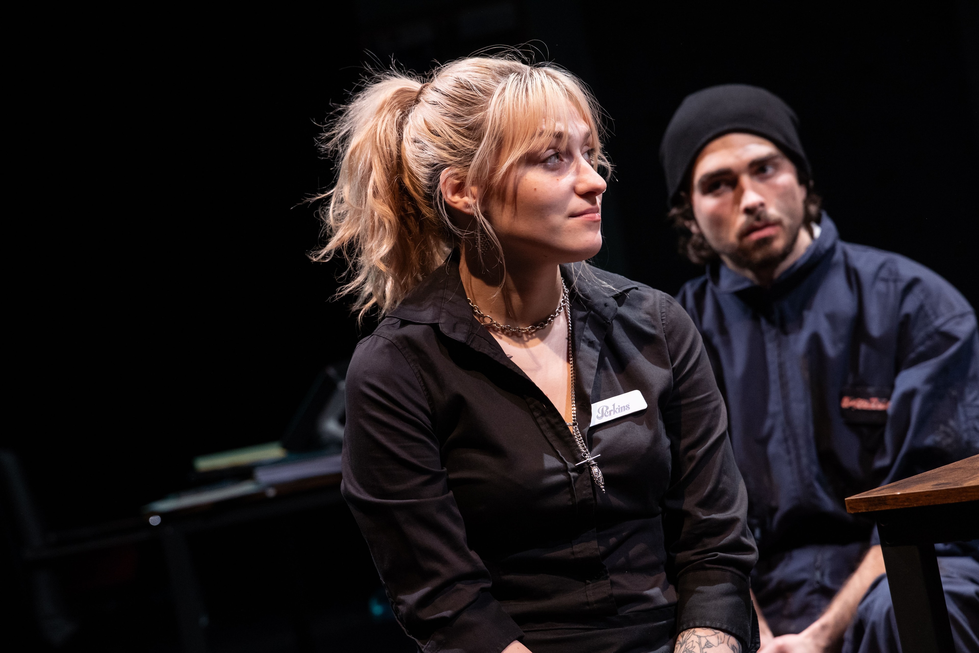 Lex Leone on stage in black uniform with co-star