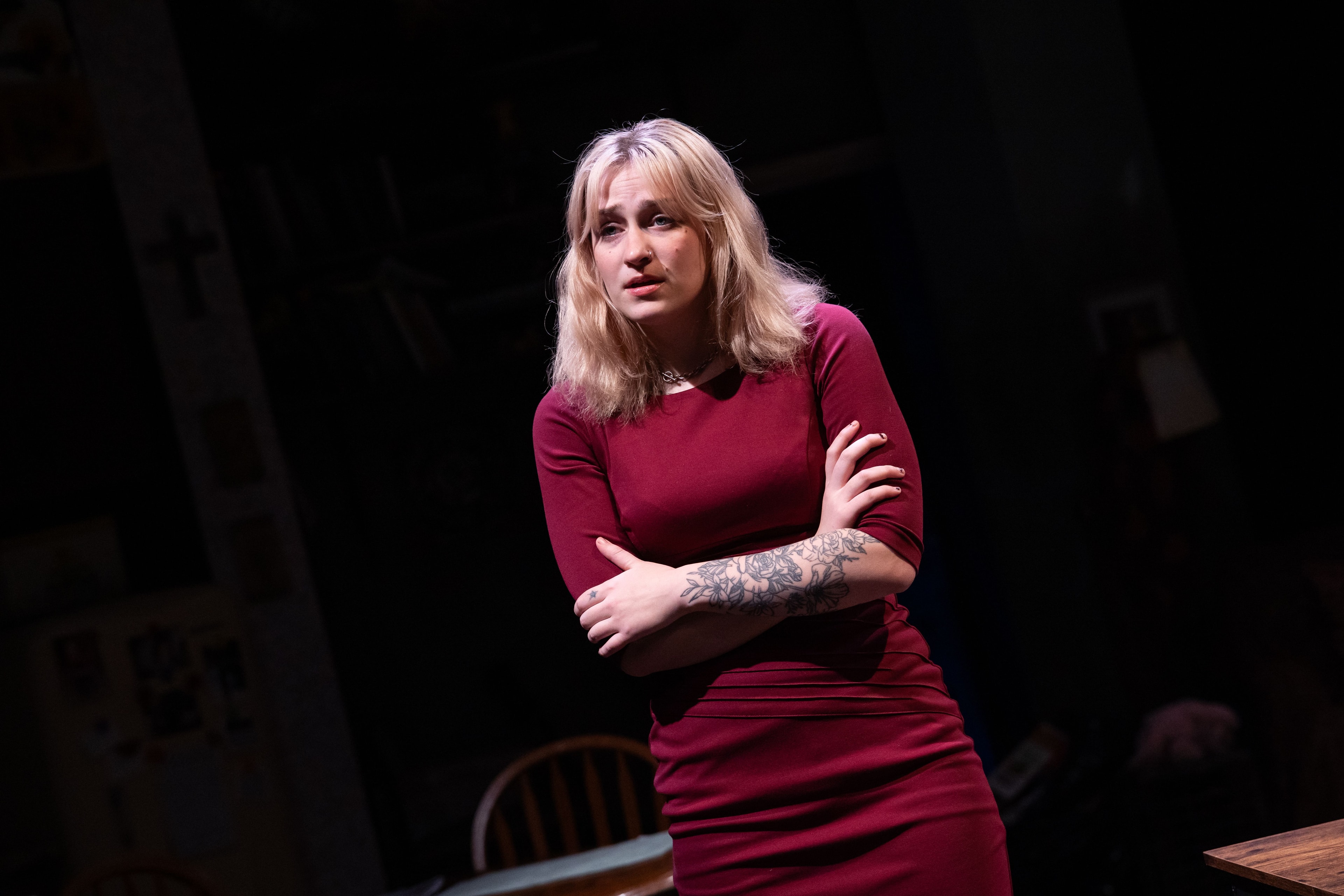 Lex Leone on stage in burgundy dress
